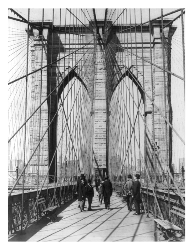 Vintage photo from 1898 of the Brooklyn Bridge with men standing on the roadway.